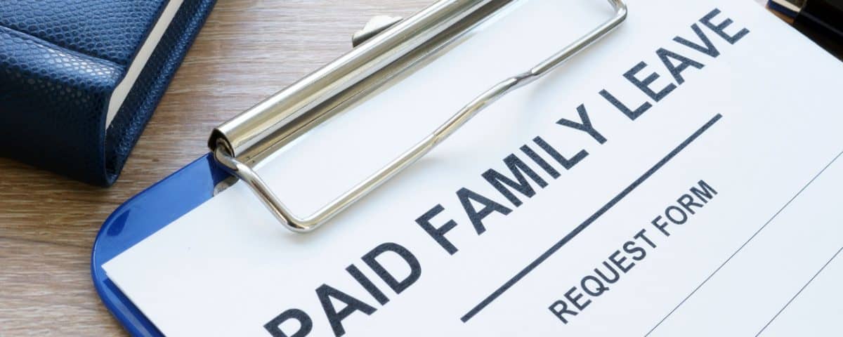 Paid family leave form in clipboard and note pad
