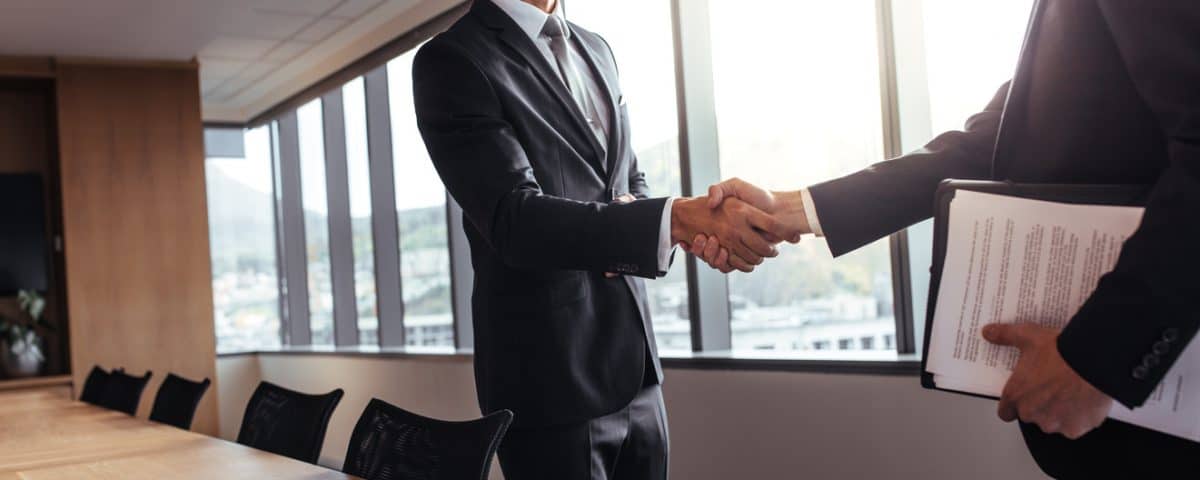 Business man shaking hands after a successful meeting